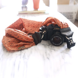 arrow orange scarf camera strap